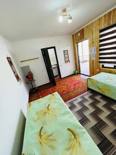 a room with a bed and two mattresses in it at Guest House KAGAN in Toktogul