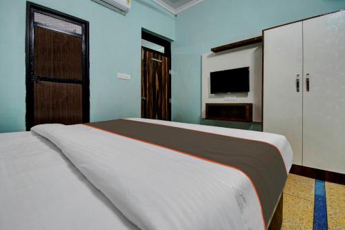 a bedroom with a large bed and a television at Collection O The Legent Hotel in Jaipur