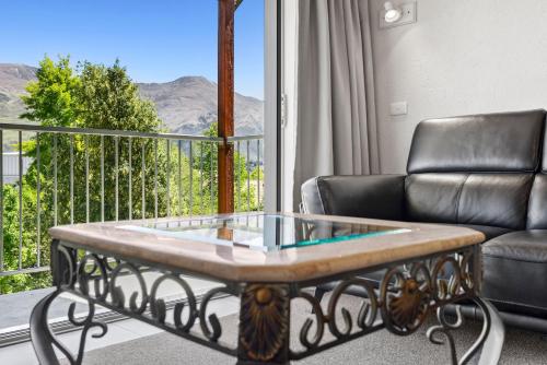 a living room with a couch and a coffee table at ASURE Brookvale Motel in Wanaka