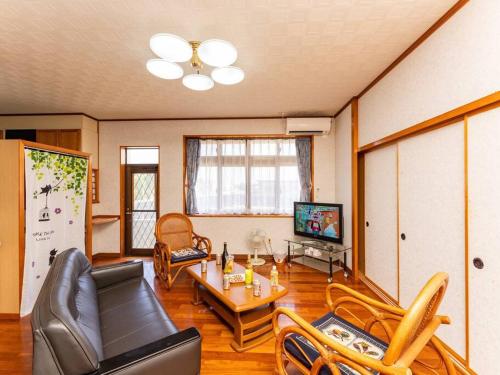 a living room with a couch and chairs and a table at AGARI 伊江島 Ie Island in Ie