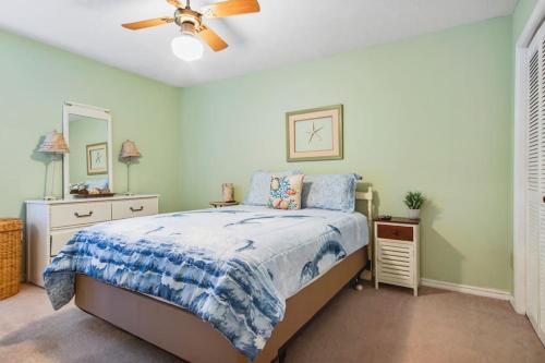 a bedroom with a bed and a ceiling fan at Kimberly Villa in Panama City Beach