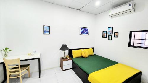 a bedroom with a bed and a desk and a table at Hanoi Cozy Homestay Long Biên in Hanoi