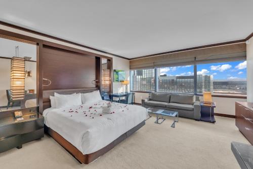 a hotel room with a large bed and a couch at VDARA HOTEL Premium Studio Suite * FREE VALET PARKING in Las Vegas