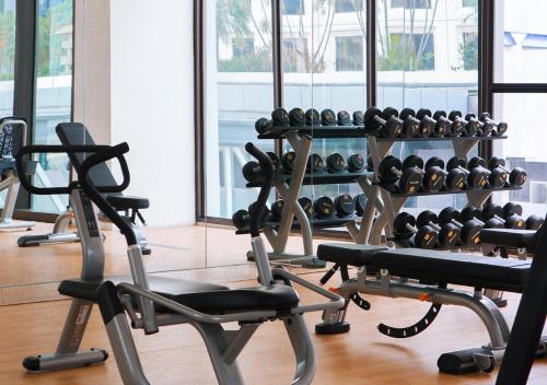 a gym with a lot of exercise equipment at Mangkuluhur Residences by Lorin in Jakarta