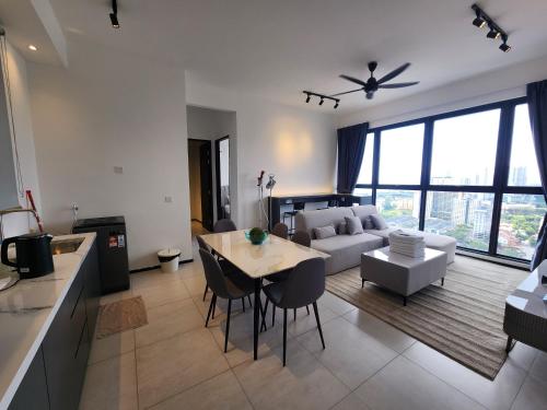 a kitchen and living room with a couch and a table at Urban Suites - Penang in Jelutong