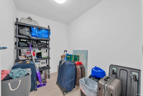 a room with a bunch of luggage and bags at Kind One Bedroom Apartment in North Vancouver