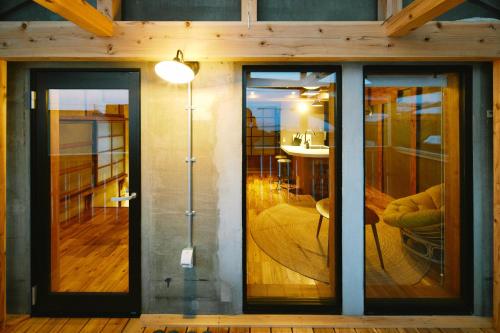 a room with sliding glass doors in a house at MUSIRO STAY and SAUNA 