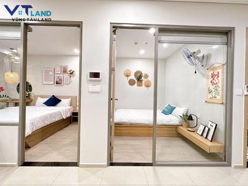 a room with a bed and a sliding glass door at The Song Vung Tau Homestay - VTLand in Vung Tau