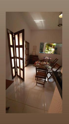 a room with a table and chairs and a door at POUSADA ECOALTER in Santarém