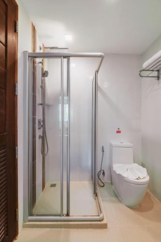 a bathroom with a shower and a toilet at Elite Suites Patong in Patong Beach