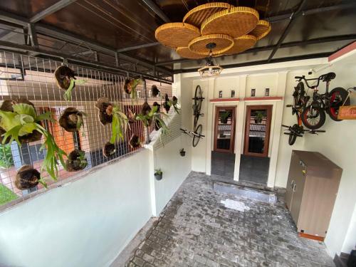 a hallway of a building with plants on the wall at Coliving Jogja SWEET HOME Kost Lengkap di Jogjakarta in Yogyakarta