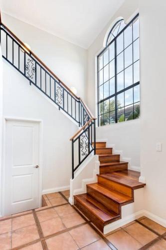 a staircase in a home with a window and a door at Luxury Waterfront Canal Estate With Private Jetty - Pet Friendly in Busselton