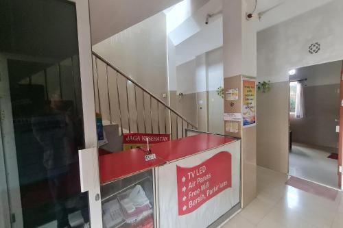 a lobby with a staircase and a red counter at Capital O 93250 Hotel Tirta Kencana 2 Baturaden in Banyumas