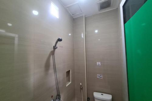 a shower stall in a bathroom with a toilet at Capital O 93250 Hotel Tirta Kencana 2 Baturaden in Banyumas