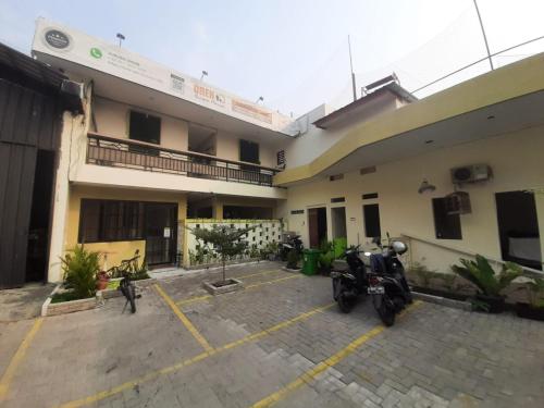 a motorcycle parked in a parking lot in front of a building at OYO 93274 Oren Home Bekasi in Bekasi