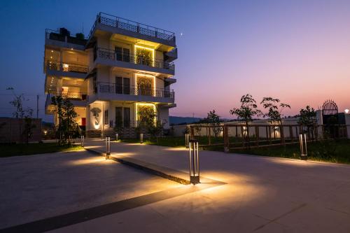 a building with lights in front of it at night at The Kaziranga Address in Kāziranga