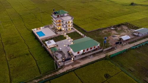 an aerial view of a house with a green roof at The Kaziranga Address in Kāziranga