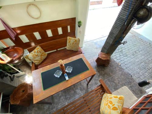 an overhead view of a wooden bench in a room at Coliving Jogja SWEET HOME Kost Lengkap di Jogjakarta in Yogyakarta