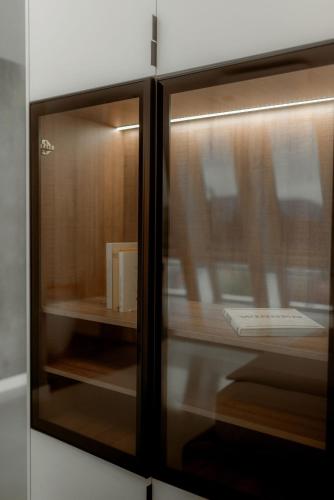 a glass door of a cabinet with a book at NED Hotel in Graz