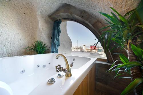 a bathroom with a sink and a window at Caverna Hotel Premium Caves in Goreme