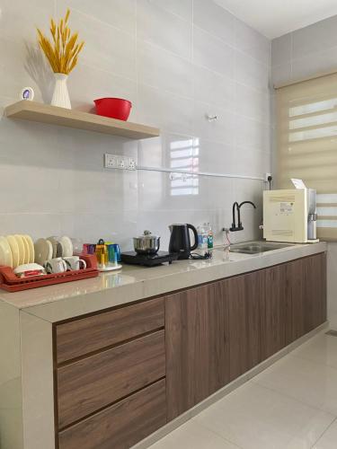 a kitchen with a sink and a counter top at LYL HOMESTAY-IPOH 10Pax 4R in Ipoh