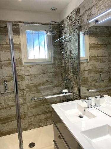 une salle de bain avec un lavabo et une douche dans l'établissement Charmante Maison au pied du Luberon, à Cheval-Blanc