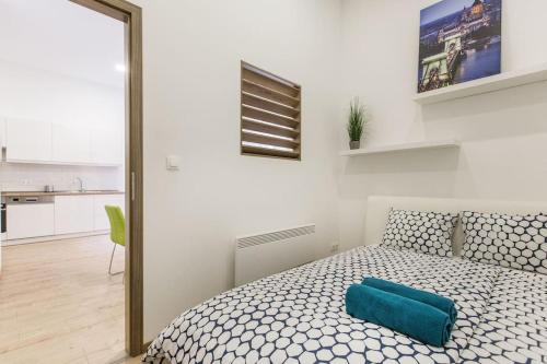 ein Schlafzimmer mit einem Bett mit einem blauen Kissen darauf in der Unterkunft Designer Dream Home In The Ruin Bar District w A/C in Budapest