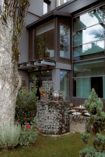 a house with a pile of rocks in the yard at NED Hotel in Graz