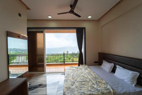een slaapkamer met een bed en een groot raam bij Colorbar Villa in Mahabaleshwar