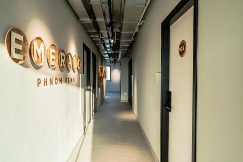 a hallway in a building with signage on the wall at Emerald Hotel Residence in Phnom Penh
