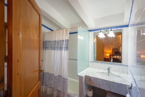 a bathroom with a sink and a mirror at Mas dels Frares in Vilafreser