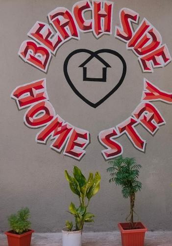 a sign for a house with a heart and a peace sign at Beach Side homestay in Mangalore