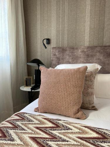 a bedroom with a bed with a pillow and a lamp at Hotel Boutique San Diego - Adults Only in La Laguna