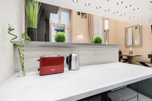 a red toaster sitting on top of a counter at Stylish two-bedroom suite in the center in Budapest