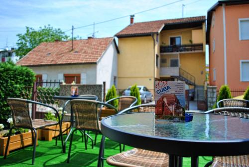 a table and chairs sitting on a patio at Hostel Cuba in Banja Luka