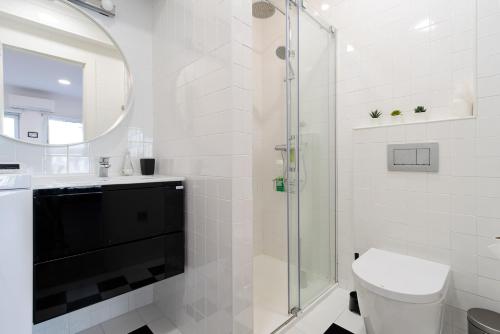 a bathroom with a shower and a toilet and a sink at AL d' Cacilhas Studio in Almada