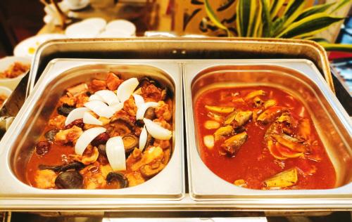 two dishes of food in a tray on a table at Linh Phuong 8 Hotel - 24 hours stay in Can Tho