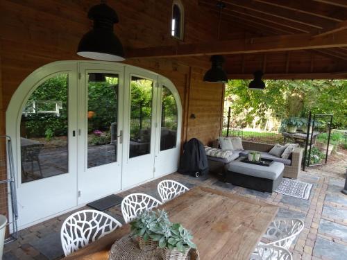 an outdoor patio with chairs and a table at Forest Villa, Kaatsheuvel in Loon op Zand