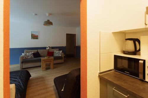 a living room with a couch and a tv at Central apartment with Terrace and a free parking in Duisburg