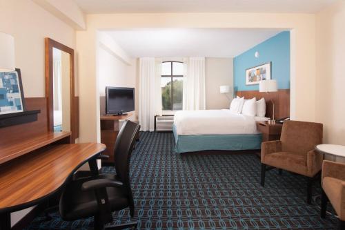 a hotel room with a bed and a television at Fairfield Inn and Suites Atlanta Airport South/Sullivan Road in Atlanta