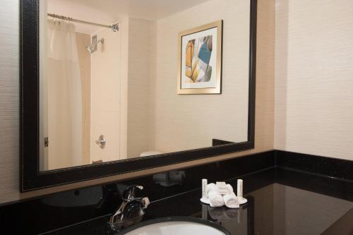 a bathroom with a sink and a large mirror at Fairfield Inn and Suites Atlanta Airport South/Sullivan Road in Atlanta