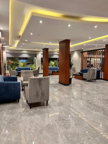 a lobby with chairs and couches in a building at Al Muhaidb Residence Al Maidan in Hafr Al Baten