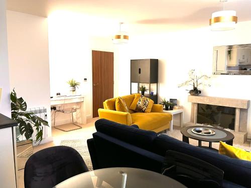 a living room with a couch and a yellow chair at City Centre Chester Waterways Apartment in Chester