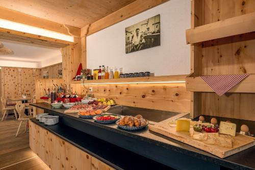 a kitchen with a counter with food on it at Birkenhof in Sluderno