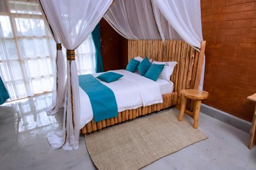 A bed or beds in a room at Mara Safari Lodge Kidepo