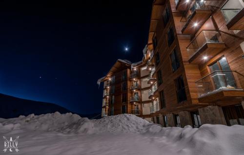 a pile of snow in front of a building at night at New Gudauri Ski4Life in Gudauri