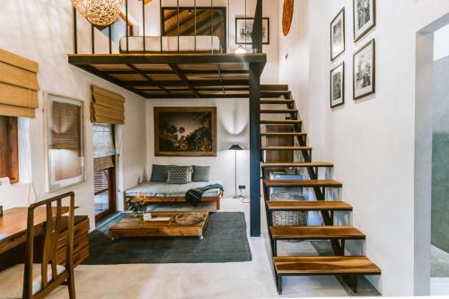 a room with a loft bed and a living room at Eraeliya Villas & Gardens in Weligama