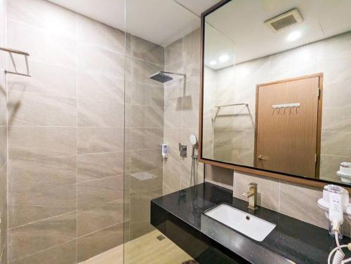 La salle de bains est pourvue d'un lavabo et d'un miroir. dans l'établissement Lovina 5-03 at Harbour Bay Residence(Ferry Terminal), à Batu Ampar