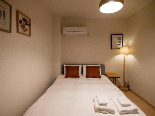 a bedroom with a large white bed with two pillows at Sumiyoshi Marie - Vacation STAY 12160 in Osaka