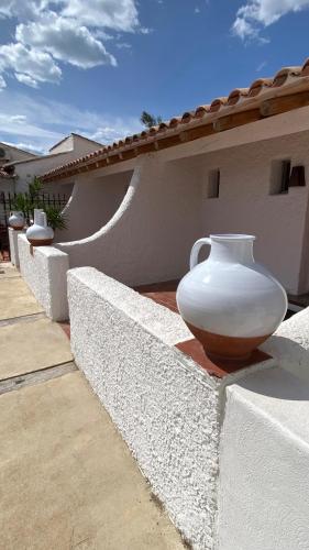 a large white vase sitting on the side of a wall at Lodge Sainte Helene Adult only in Saintes-Maries-de-la-Mer